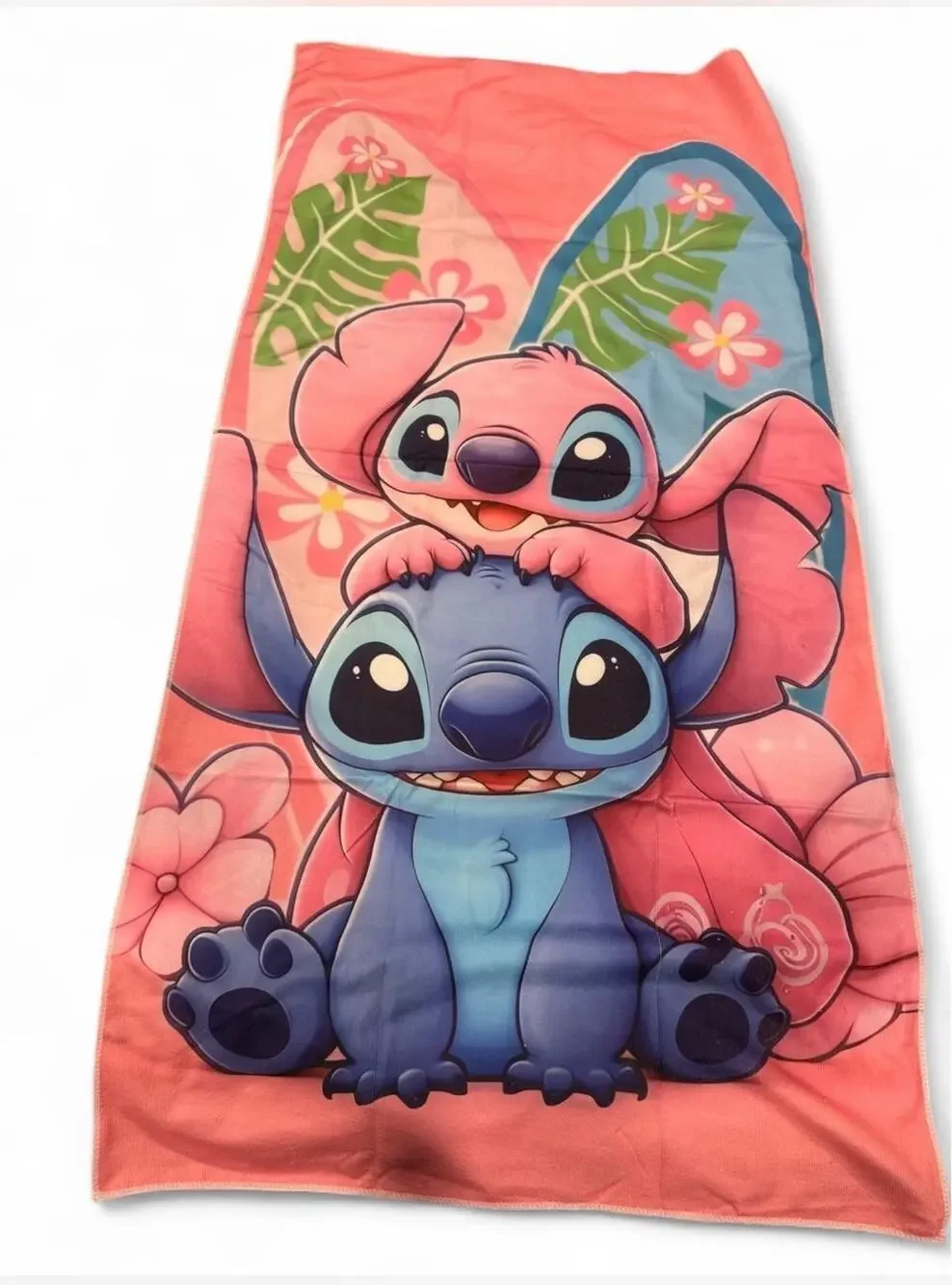 Stitch & Angel beach towel Stitch and Angel with tropical leaves and flowers